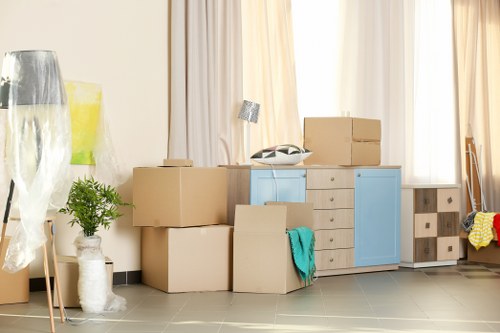 Packed moving boxes and furniture ready for transport in Catford