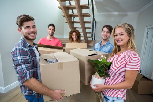 Moving boxes and furniture during a removals service in Catford